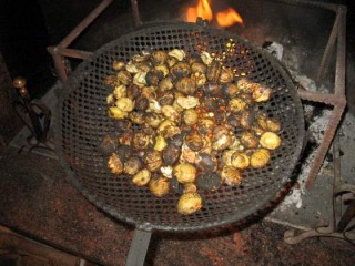 Grande padella di ferro con brodo bollente per cuocere la paella sul fuoco  aperto con legna — Rustico, caldo - Stock Photo